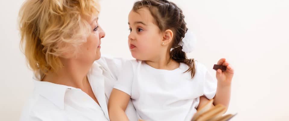 little girl sitting with her grandmother