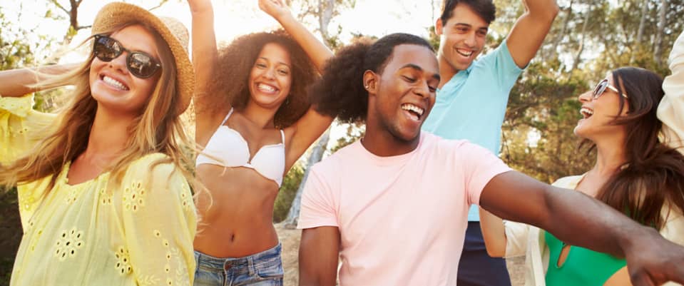 a group of male and female friends having fun outdoors