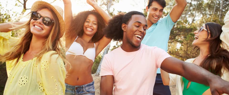 a group of male and female friends having fun outdoors