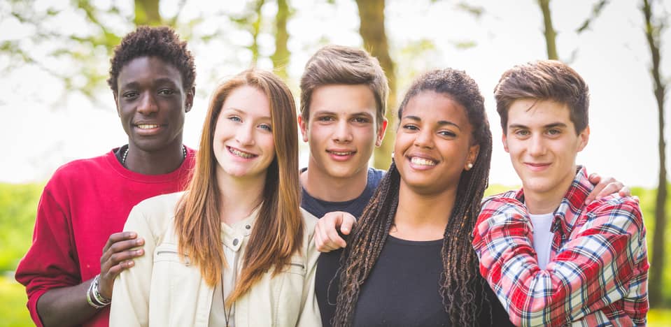 multiethnic teenagers posing from a group photo outdoors