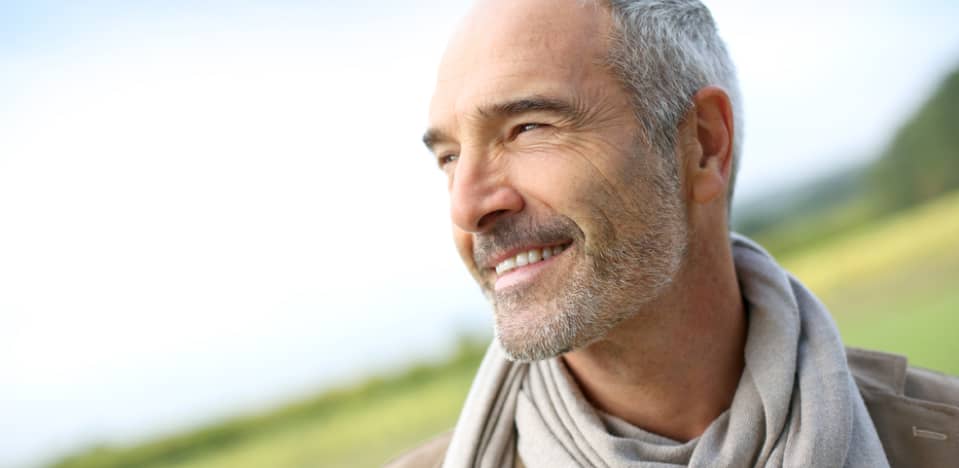 closeup of a smiling elderly man outdoors