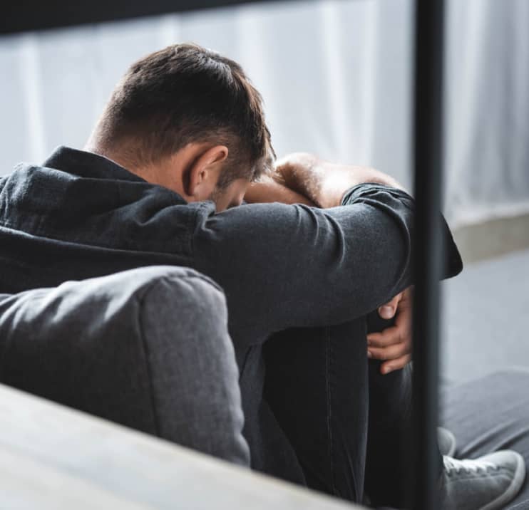 img - back-view-man-panic-attack-crying-hugging-legs-apartment